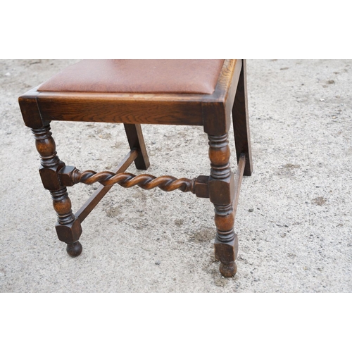 647 - Set of four oak dining chairs with barley twist supports and carved crown details to backs, with lea... 