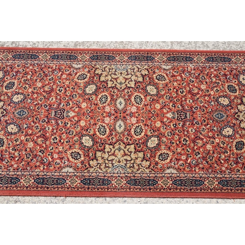 765 - Super Keshan hand-made red ground carpet / runner of geometric design, approximately 350 x 90cm