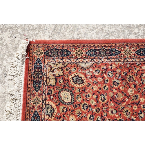 765 - Super Keshan hand-made red ground carpet / runner of geometric design, approximately 350 x 90cm