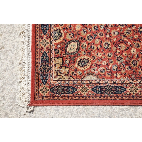 765 - Super Keshan hand-made red ground carpet / runner of geometric design, approximately 350 x 90cm