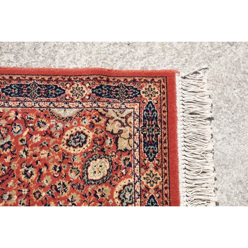 765 - Super Keshan hand-made red ground carpet / runner of geometric design, approximately 350 x 90cm