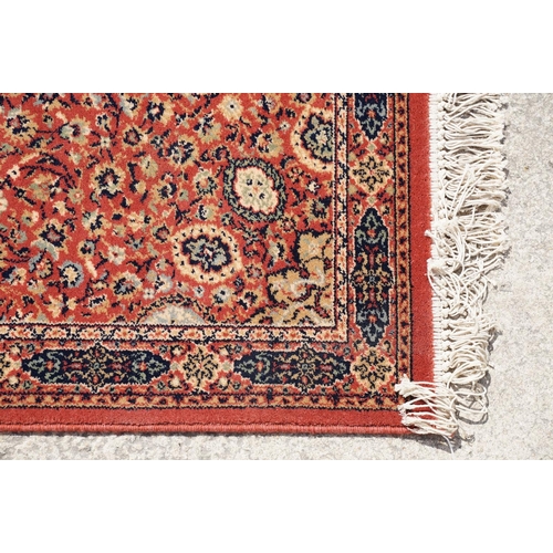 765 - Super Keshan hand-made red ground carpet / runner of geometric design, approximately 350 x 90cm