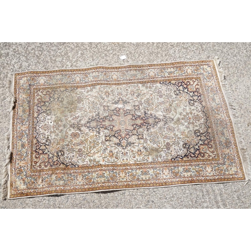 766 - Middle Eastern cream ground carpet, with central stylised motif within geometric borders, 160 x 92cm... 