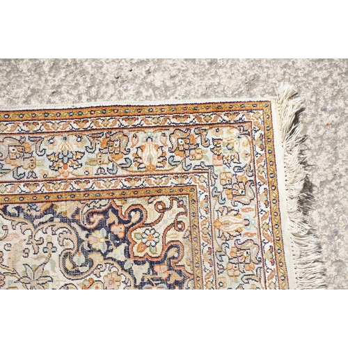 766 - Middle Eastern cream ground carpet, with central stylised motif within geometric borders, 160 x 92cm... 