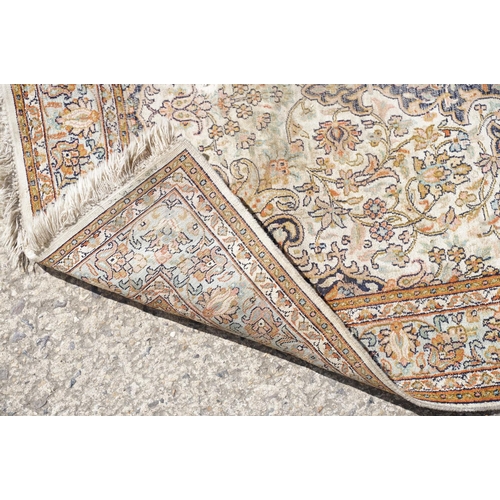 766 - Middle Eastern cream ground carpet, with central stylised motif within geometric borders, 160 x 92cm... 