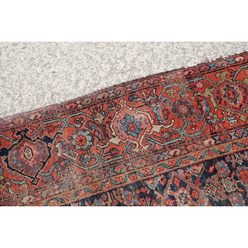 770 - Middle Eastern red ground carpet of geometric design, 310 x 142cm