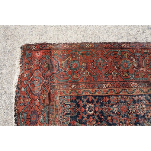 770 - Middle Eastern red ground carpet of geometric design, 310 x 142cm