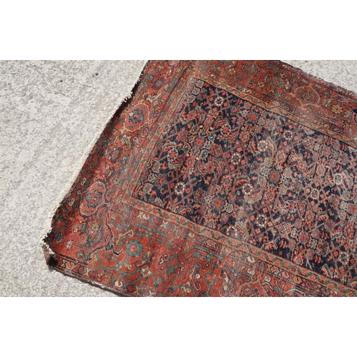 770 - Middle Eastern red ground carpet of geometric design, 310 x 142cm