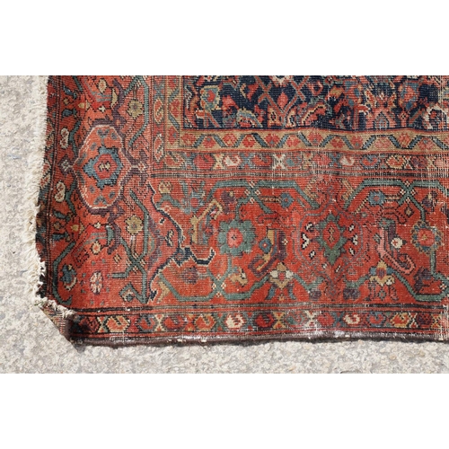 770 - Middle Eastern red ground carpet of geometric design, 310 x 142cm