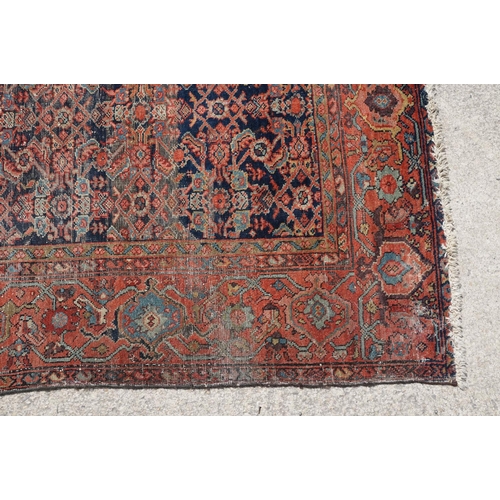 770 - Middle Eastern red ground carpet of geometric design, 310 x 142cm