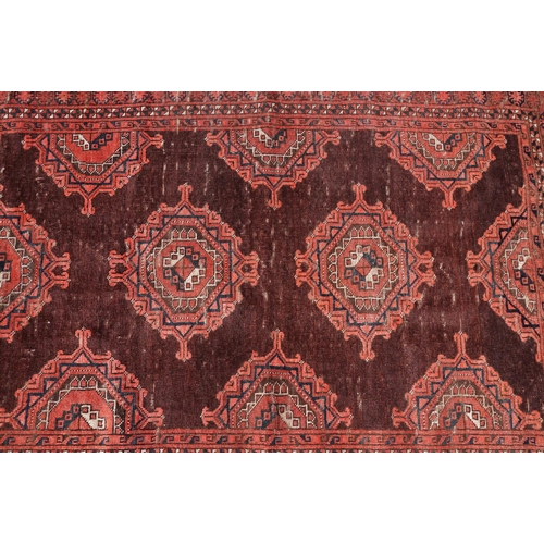 771 - Middle Eastern red ground carpet, with two central medallions within geometric borders, 216 x 140cm