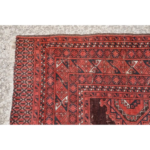 771 - Middle Eastern red ground carpet, with two central medallions within geometric borders, 216 x 140cm