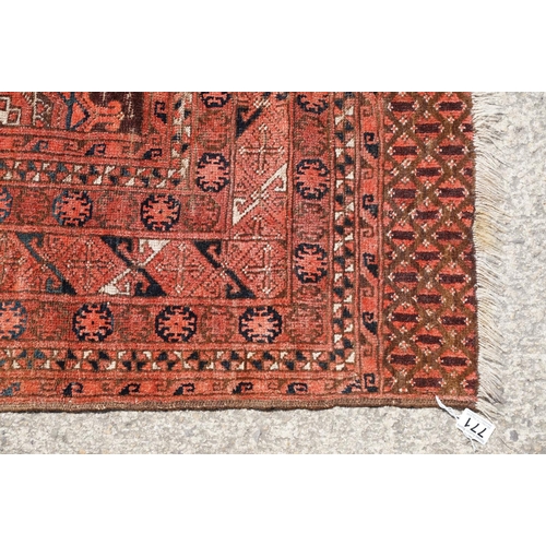 771 - Middle Eastern red ground carpet, with two central medallions within geometric borders, 216 x 140cm