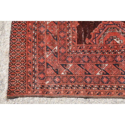 771 - Middle Eastern red ground carpet, with two central medallions within geometric borders, 216 x 140cm