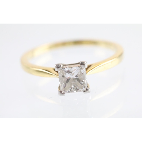 10 - 18ct gold and platinum diamond solitaire ring. The ring being set with a rectangular princess cut di... 