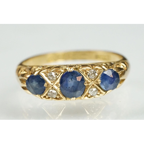 18 - 18ct gold sapphire and diamond ring. The ring being set with a central oval cut sapphire to centre f... 