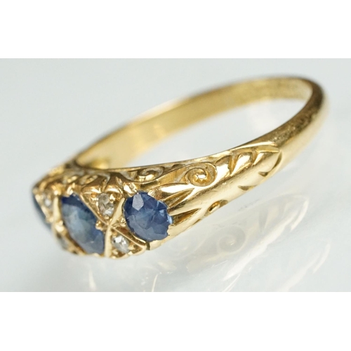 18 - 18ct gold sapphire and diamond ring. The ring being set with a central oval cut sapphire to centre f... 