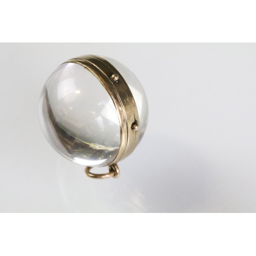 25 - 19th Century Victorian pool of light rock crystal locket of orb shape with 9ct gold banding, housing... 