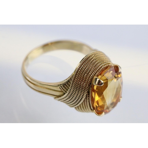 26 - 18ct gold and citrine dress ring being set with an oval cut citrine to the head within a rope twist ... 