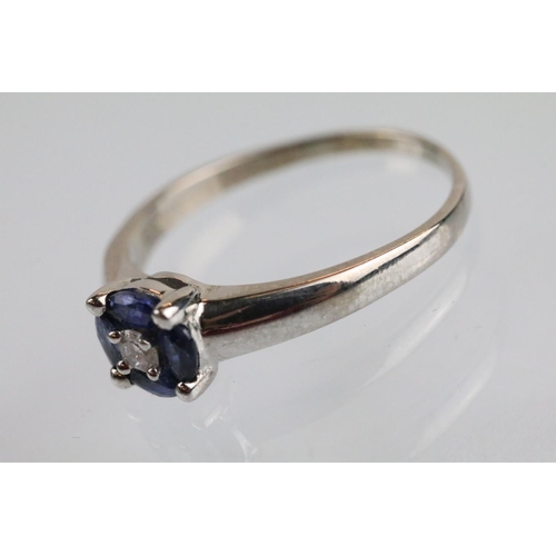 28 - 18ct white gold diamond and synthetic sapphire cluster ring being set with a round brilliant cut dia... 