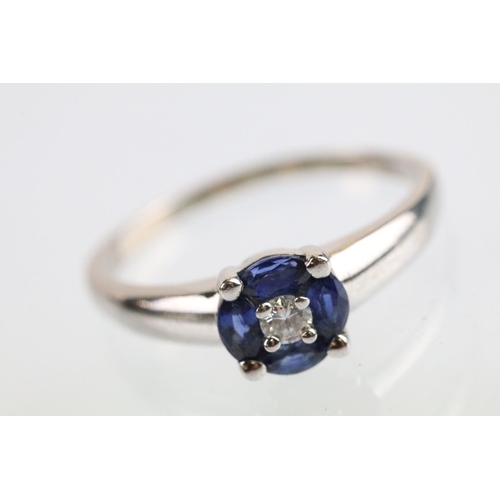 28 - 18ct white gold diamond and synthetic sapphire cluster ring being set with a round brilliant cut dia... 