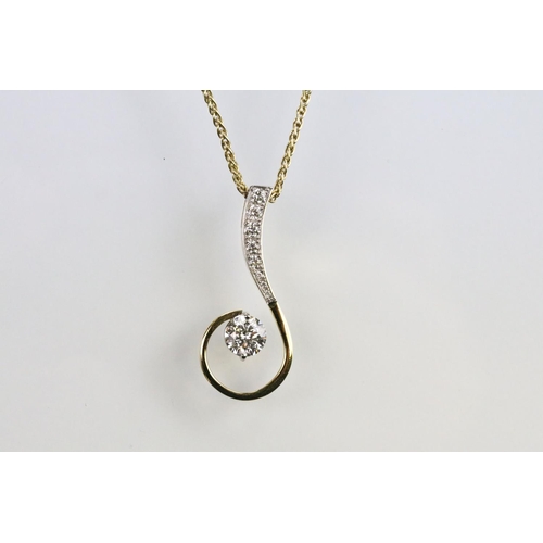 30 - 18ct gold and diamond pendant necklace. The pendant of swirl design being set with a round fancy cut... 