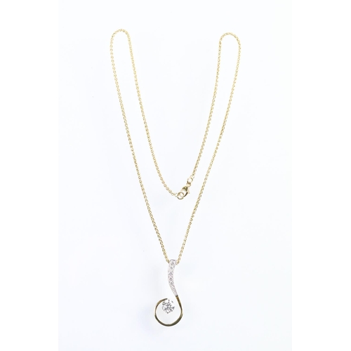 30 - 18ct gold and diamond pendant necklace. The pendant of swirl design being set with a round fancy cut... 