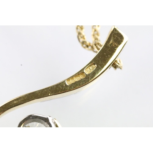 30 - 18ct gold and diamond pendant necklace. The pendant of swirl design being set with a round fancy cut... 