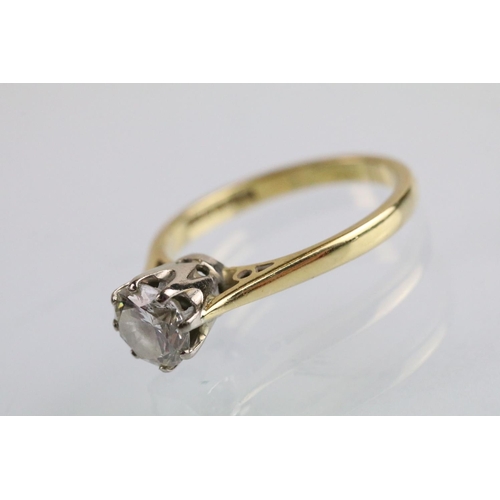 31 - 18ct gold and diamond solitaire ring. The ring set with a round brilliant cut diamond in a cathedral... 