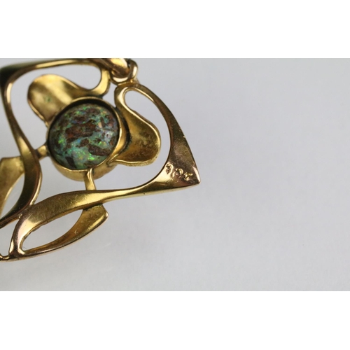 32 - Early 20th Century Art Nouveau 9ct gold and opal pendant of whiplash form with a round opal cabochon... 