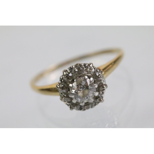 50 - Early 20th Century diamond cluster ring. The ring being set with an old round cut diamond to centre ... 