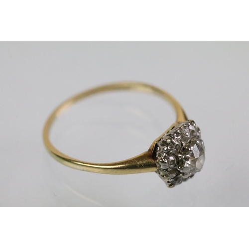 50 - Early 20th Century diamond cluster ring. The ring being set with an old round cut diamond to centre ... 