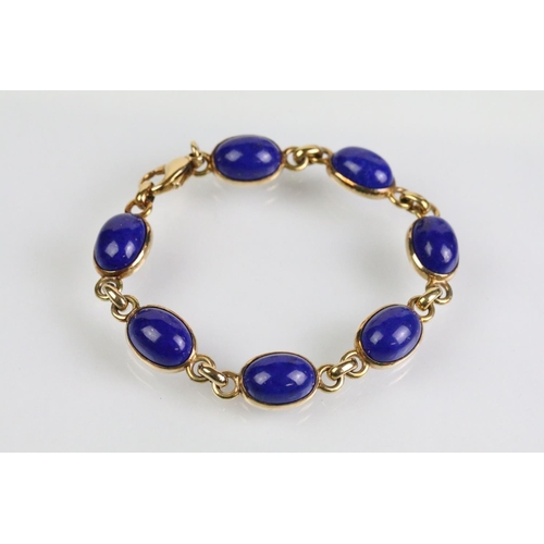 52 - 9ct and lapis lazuli necklace, bracelet and earrings. The bracelet set with seven lapis lazuli caboc... 