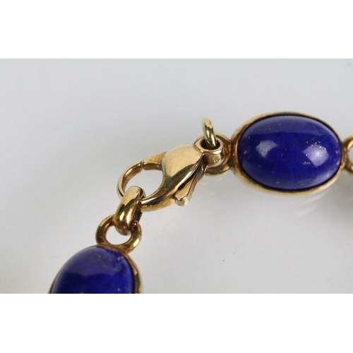 52 - 9ct and lapis lazuli necklace, bracelet and earrings. The bracelet set with seven lapis lazuli caboc... 