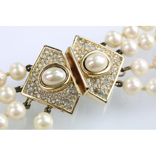 57 - Christian Dior - Four strand simulated pearl necklace having a white stone set clasp with half pearl... 