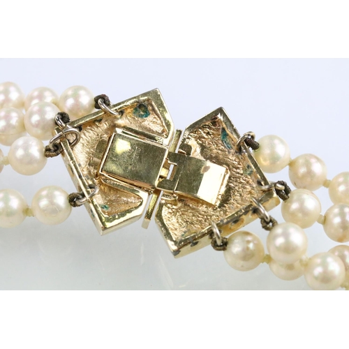 57 - Christian Dior - Four strand simulated pearl necklace having a white stone set clasp with half pearl... 