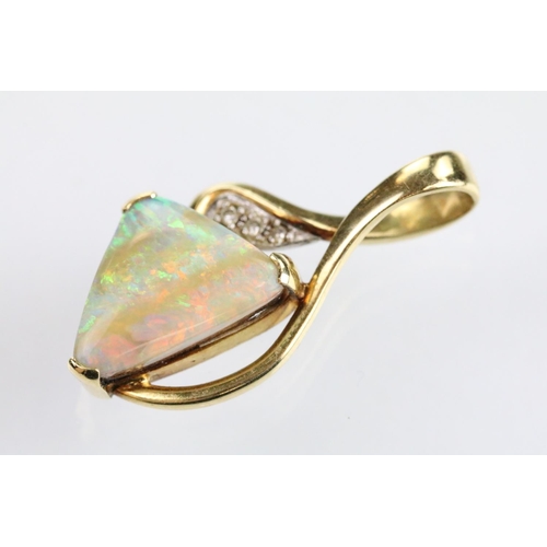 61 - 18ct gold opal and diamond pendant being set with a polished triangular opal displaying a full spect... 