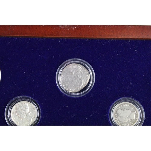 102 - A set of early american silver coins encapsulated within wooden fitted display case.