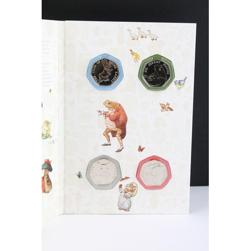 133 - A collection of Beatrix Potter 50p coins within three Royal Mint collectors folders.