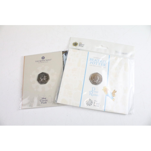 134 - A collection of fifteen Royal Mint Beatrix Potter 50p coin collectors packs together with five Winni... 