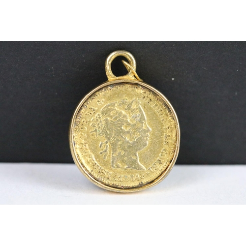 142 - A Spanish 1864 gold 1 Real coin within a gold mount.