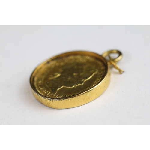 142 - A Spanish 1864 gold 1 Real coin within a gold mount.