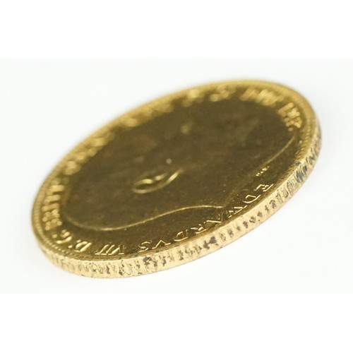 233 - A British King Edward VII 1903 gold full sovereign coin mounted within a 9ct gold mount.