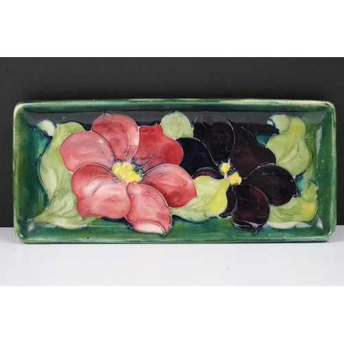 86 - Moorcroft Clematis pattern green ground rectangular tray, label to reverse, approx 20.5cm long