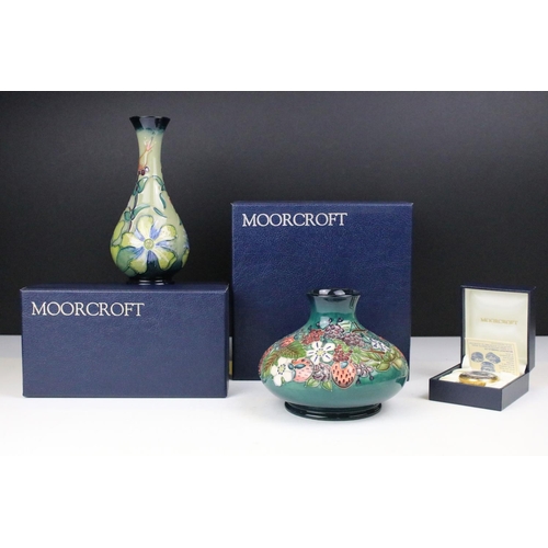 87 - Two boxed Moorcroft pottery vases to include a Carousel squat vase (11cm tall), and a Hypericum balu... 
