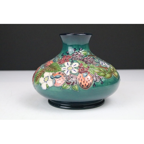 87 - Two boxed Moorcroft pottery vases to include a Carousel squat vase (11cm tall), and a Hypericum balu... 