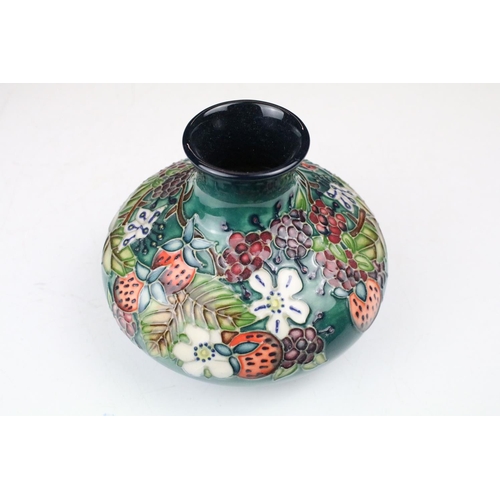 87 - Two boxed Moorcroft pottery vases to include a Carousel squat vase (11cm tall), and a Hypericum balu... 