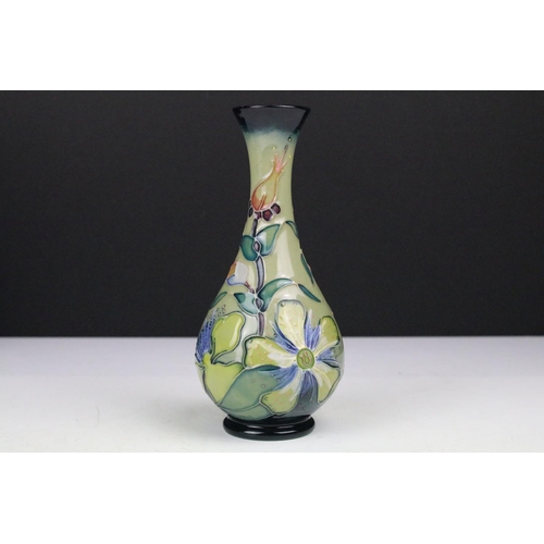 87 - Two boxed Moorcroft pottery vases to include a Carousel squat vase (11cm tall), and a Hypericum balu... 