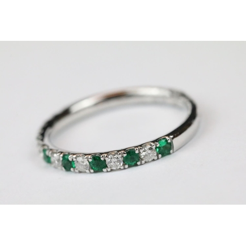 261 - Platinum, emerald and diamond half eternity ring, approx. 1/2 carat