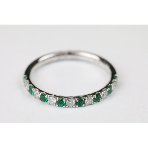 261 - Platinum, emerald and diamond half eternity ring, approx. 1/2 carat